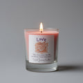 Candle with a 'Love' label on a gray background