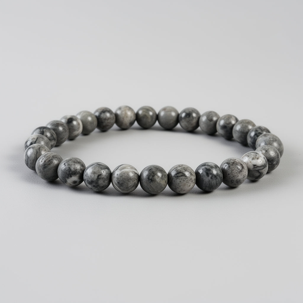 Beaded bracelet with gray and brown stones on a light gray background