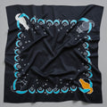 Black cloth with cat and moon designs on a gray background