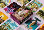 Collection of tarot cards with colorful artwork on a pink background