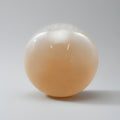 Spherical object with gradient color from white to orange on a gray background
