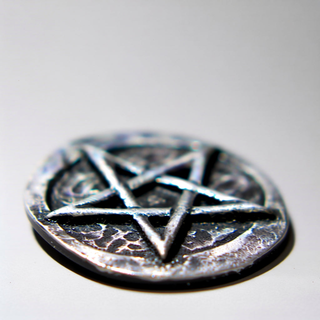 Pentagram pocket stone on a reflective surface with a blurred background