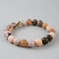 Multicolored beaded bracelet on a light gray background