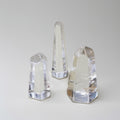 Three crystal bookends of different sizes on a gray background