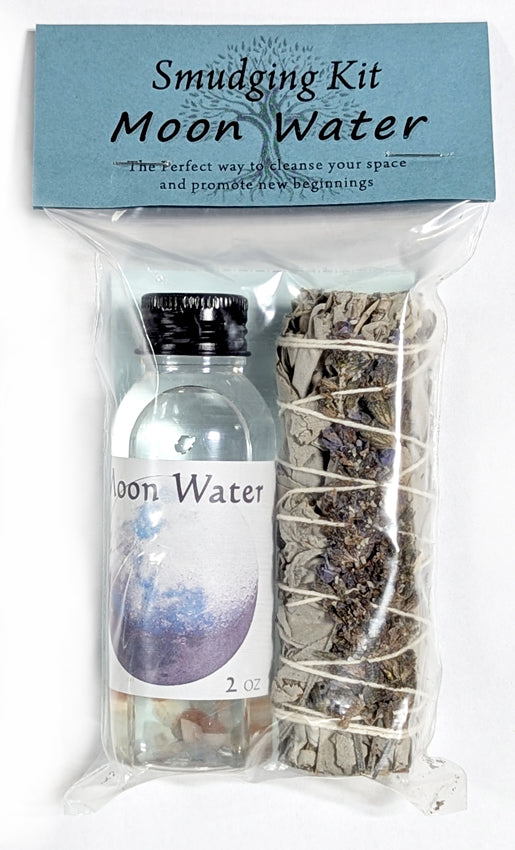 Smudging kit with moon water and sage in a clear bag on a white background