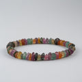Multicolored gemstone bracelet on a light gray background