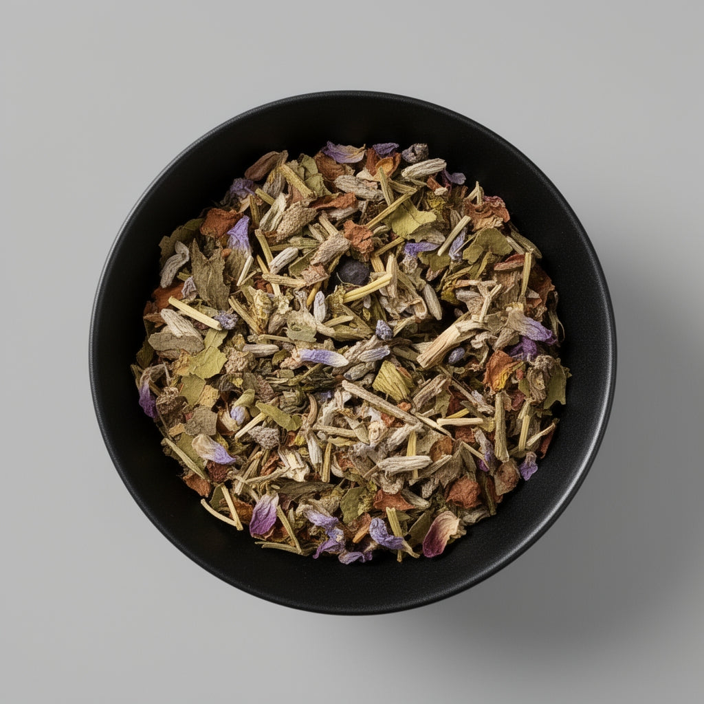 Black bowl filled with dried herbs on a gray background