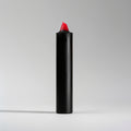 Black and red candle on a light gray background