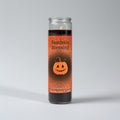 Candle with 'Samhain Blessing' label and pumpkin design on an orange background