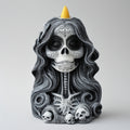 Decorative skull figurine with long hair and a yellow incense cone on a white background
