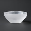 White selenite bowl on a dark gray background