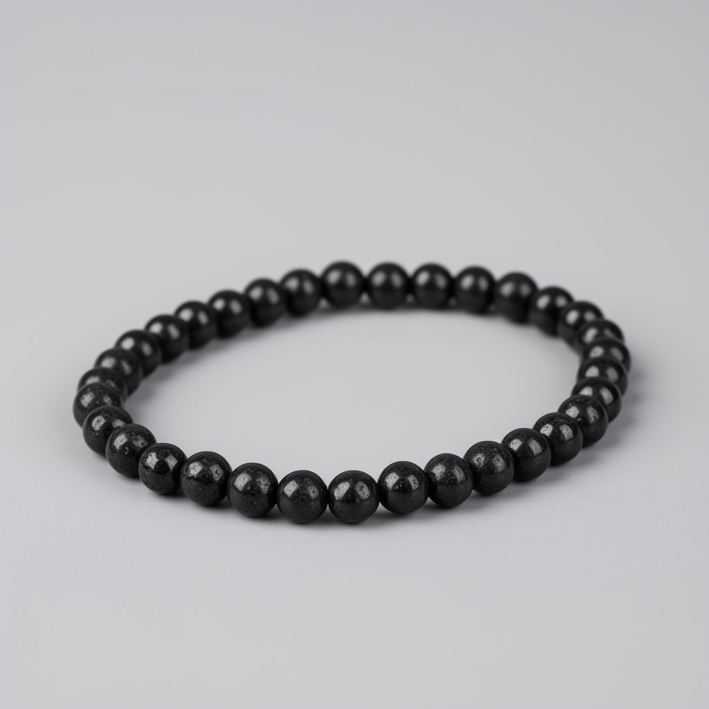 Black beaded bracelet on a light gray background