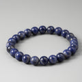 Blue beaded bracelet on a gray background