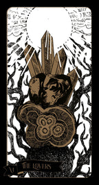 Tarot card featuring a hand holding crystals with a black and white background