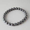 Metallic beaded bracelet on a light gray background