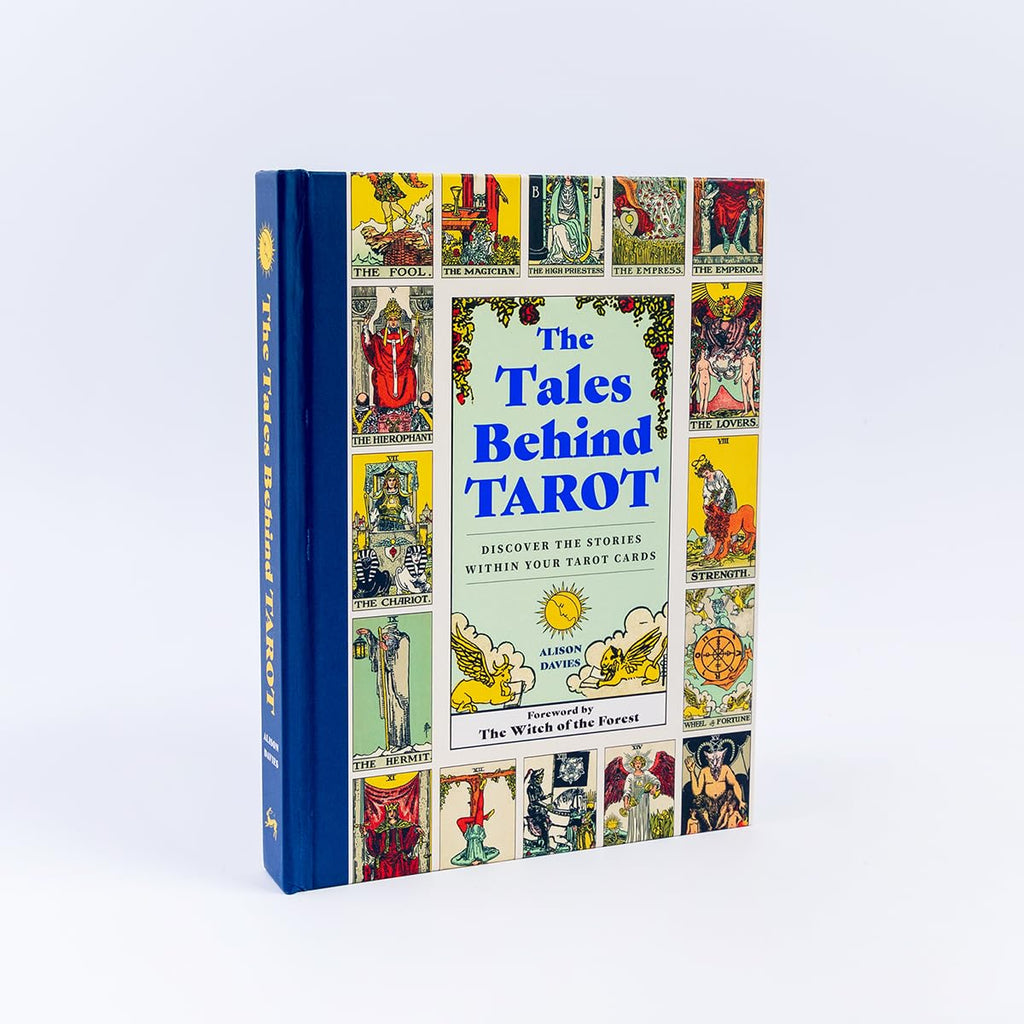 The Tales Behind Tarot, a hardcover book with a blue spine and cover featuring colorful tarot card illustrations, photographed on a clean white background.