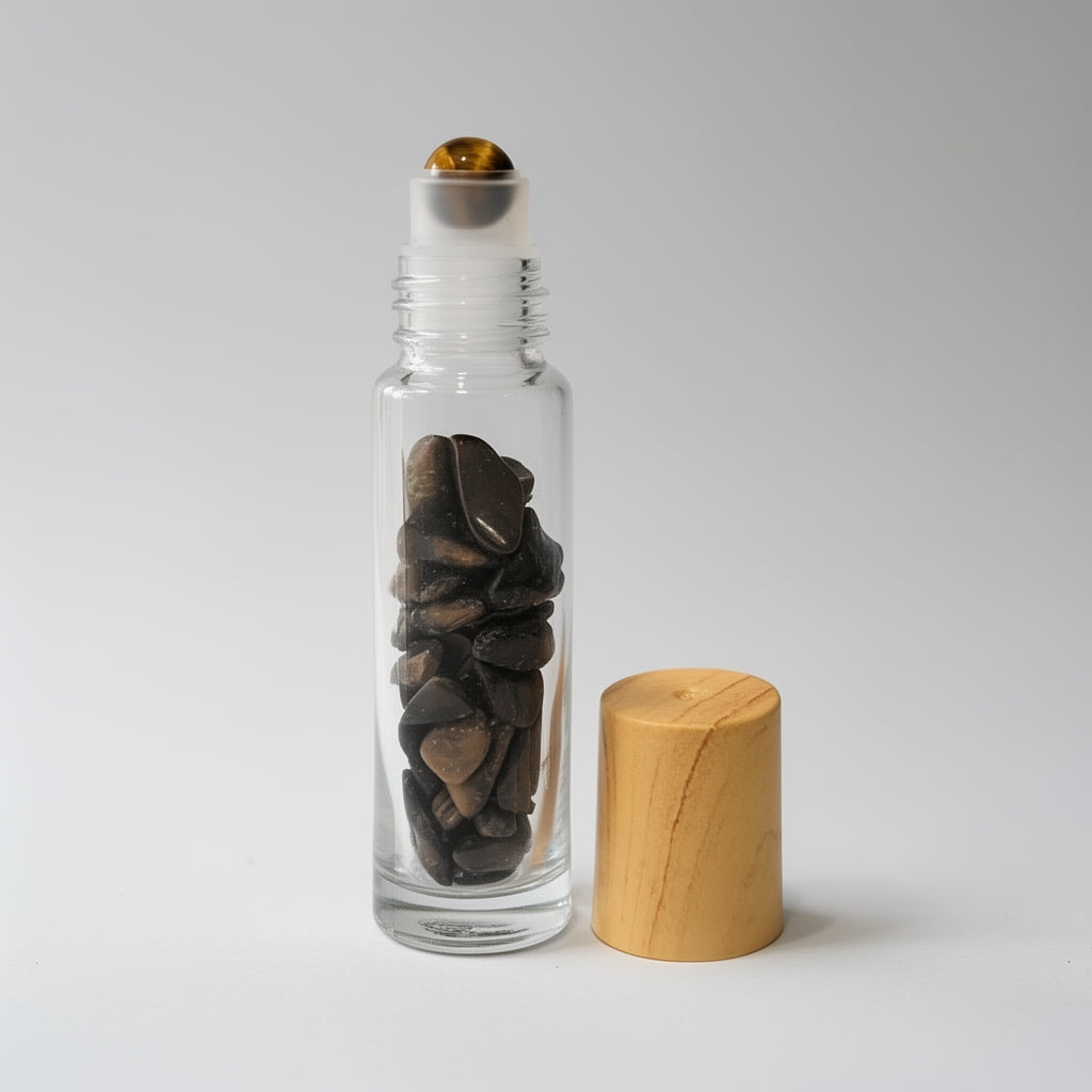 Clear glass bottle with stones inside and a wooden cap on a light gray background
