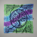Tie-dye bandana with a tree of life design on a plain background
