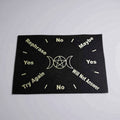 Black cloth with white text and symbols on a gray background