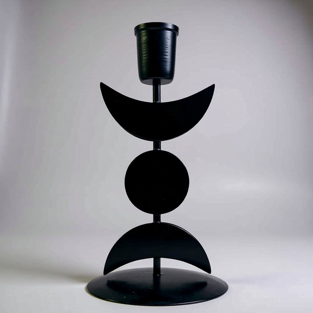 Black metal candle holder with geometric design on a white background
