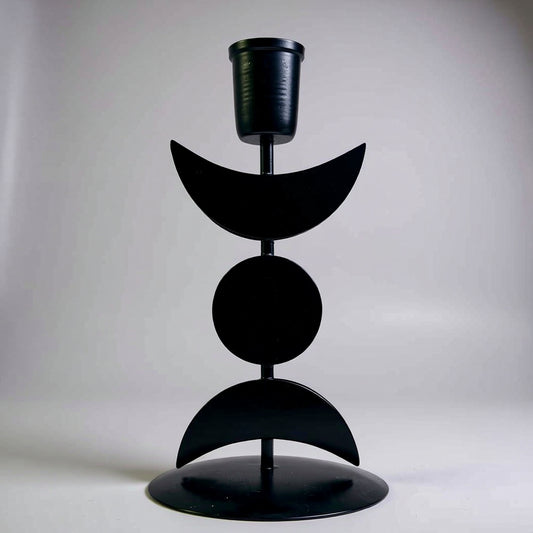 Black metal candle holder with geometric design on a white background