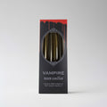 Box of 'Vampire Tears Candles' with black tapers on a gray background