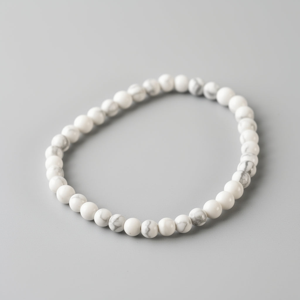 White beaded bracelet on a gray background