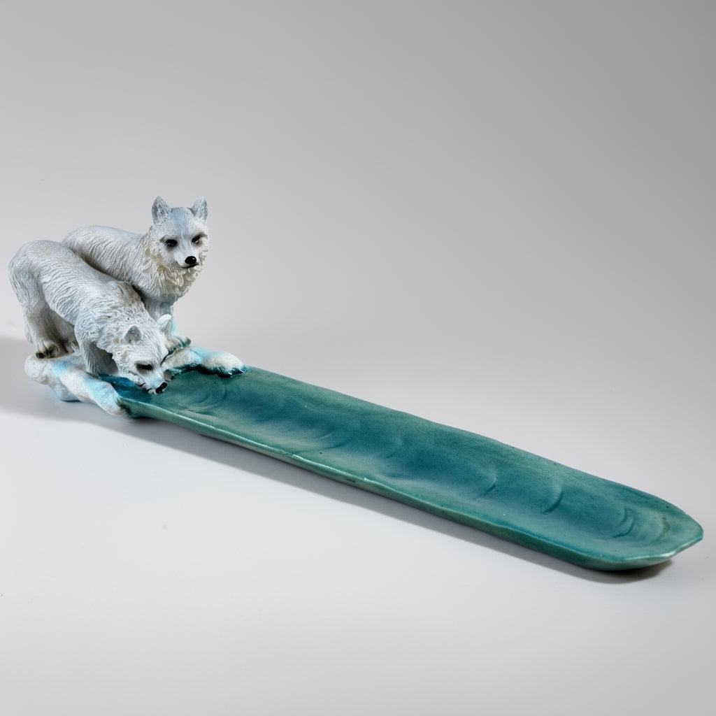 Teal ceramic tray with two white wolves on a gray background