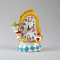 Decorative clock with a yellow frame and blue base on a gray background