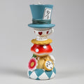 Colorful ceramic figurine with a blue top hat and checkered base on a gray background